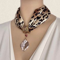 A square  leopard skin scarf in black/ brown shads with a beautiful natural stone scarf pendant.   The base of the pendant is made of a decorated bronze spring opening & closing system. The jewelry crafted with one polished slide of Zebradorite stone with a creamy white base . Impressive, feminine and adds classic style luxury to any look. A multi-purpose gift for a woman you love. The pieces can be worn separately with another scarf or on a choker neckline top Size of the scarf:18 1/2inches x 1 Womens Scarf, Diy Scarf, Scarf Necklace, Leopard Skin, Scarf Rings, Luxury Scarves, Scarf Jewelry, Pretty Gift, Beaded Jewelry Diy