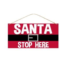 a santa sign hanging on a wall