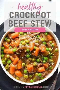 healthy crockpot beef stew with peas and carrots in a white bowl on a black plate