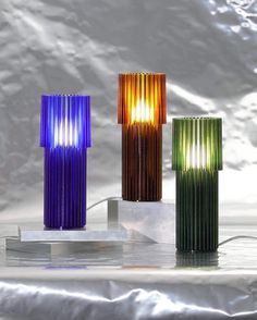 three different colored lamps sitting next to each other