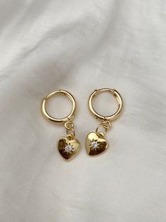 Brand new  💕Handmade by yours truly  Beautiful high quality and lead free. Huggies, charm and all findings are 18K gold plated and tarnish resistant.  COLOURGold  SIZE1.1cm diameter Huggie 0.9cm charm Material18K Plated Gold Brass Weight8.6g 💌 Price includes free untracked shipping within Australia *These earrings are made to sit front facing. Please refer to try on picture. If you prefer side facing, please leave a comment at checkout  **These huggies have an 1mm thick ear pin which may not b Gold Dangle Heart Earrings With Cubic Zirconia, Gold Cubic Zirconia Heart Dangle Earrings, Gold Cubic Zirconia Dangle Heart Earrings, Gold Cubic Zirconia Earrings With Heart Charm, Gold Cubic Zirconia Heart Earrings In Dainty Style, Gold Dainty Heart Earrings With Cubic Zirconia, Dainty Gold Heart Earrings With Cubic Zirconia, Gold Hoop Earrings With Heart Charm, Ear Pin