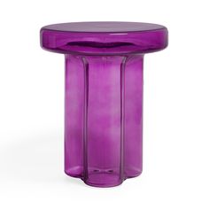 a purple glass table sitting on top of a white floor