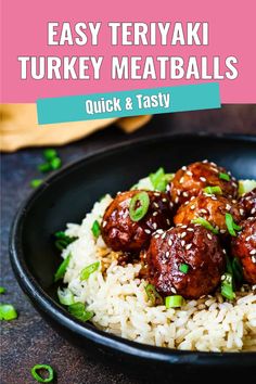 a black plate filled with meatballs and rice on top of a table next to green onions