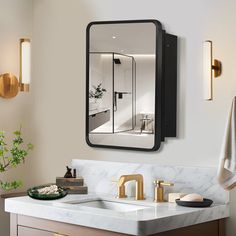 a bathroom sink with a mirror above it and gold faucets on the wall