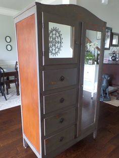 a wooden cabinet with drawers in a living room