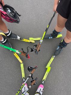 four pairs of skis and poles in the middle of a circle with their legs crossed