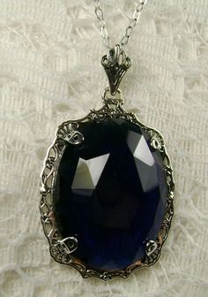 "Pendant Description Custom Inspired by Victorian era designs, I now offer this lovely Antique reproduction in sterling silver. The flawless simulated 22ct faceted blue sapphire is 24mm long (15/16th\") and 18mm in width (3/4th\"). The entire pendant is 1.5\" long and 7/8\" wide. The chain (if chosen) is between 16-18\" in length and is marked 925 as well. Notice the beautiful craftsmanship of the Victorian filigree setting. This pendant necklace is a true reproduction of and old Victorian cameo Silver Sapphire Necklace Hallmarked, Blue Victorian Filigree Jewelry, Silver Sapphire Filigree Jewelry, Silver Sapphire Oval Pendant Jewelry, Silver Sapphire Jewelry With Filigree, Silver Sapphire Jewelry For Jewelry Making, Hallmarked Sapphire Jewelry As Gift, Elegant Oval Nickel Free Necklace, Blue Large Pendant Jewelry For Anniversary