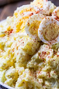 a bowl filled with mashed potatoes topped with an egg and seasoning on top