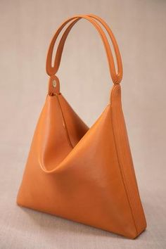 Tan corded tote bag with corded loop detail in faux leather base.
Composition: Body Material: 100% PU, Faux leather; Lining Material: 100% Poly Twill
Color: Brown
Corded collapsible tote
Corded loop detail
Pouch, key holder, side pocket on inside
Size (in inches):
Bag: L x W x D: 13.5 x 2.5 x 12
Handle Drop: 6 - Aza Fashions Modern Hobo Bag With Braided Handles, Modern Brown Bucket Bag With Rolled Handles, Leather Hobo Bag With Round Handle For Errands, Leather Hobo Bucket Bag With Rolled Handles, Tote Bag Accessories, Tan Tote Bag, Personal Shopping Service, Mens Accessories Jewelry, Digital Gift Card