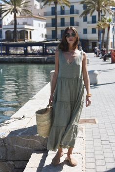 Style // A subtle, soothing and summer infused sage green linen maxi dress V-neck line and low back dress, The Sevilla Dress is a true goes-with-anything essential, guaranteed to turn heads in this timeless linen maxi dress with tie closures at the shoulders, and a tiered body for added dimension and versatility. With that perfect flowy and relaxed fit, the stunning Sevilla Dress was designed to be dressed up with a strappy sandal or barefoot for that effortlessly beautiful look! Fabric Note // Linen V-neck Sundress Maxi Dress, Chic Linen Maxi Dress For Day Out, Chic Green Linen Beach Dress, Linen Maxi Dress For Brunch, Chic Linen Maxi Dress For Summer, Chic Maxi Linen Dress For Brunch, Linen Chic Maxi Dress, Chic Linen Maxi Dress, Sage Dresses For Summer Beach