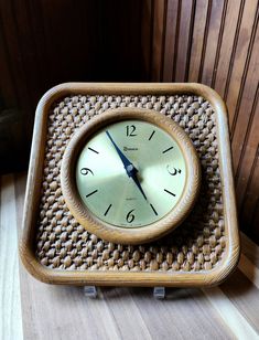 a clock sitting on top of a wooden table