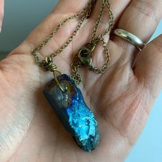 "An absolutely stunning cobalt blue titanium coated rough raw Quartz sits as a lonesome dove wrapped in rustic brass wire and is suspended from a rustic brass chain. Please make chain length choice at checkout. Enjoy! each one is made to order- expect slight variations in your crystal. Crystal will be approx 1.25\"- 1.5\" in length I hope you enjoy my handmade creations, or that special vintage notion you found in my shop! x and o , Chymiera" Blue Raw Stone Spiritual Jewelry, Spiritual Blue Raw Stone Jewelry, Unique Blue Mineral Crystal Necklace, Bohemian Blue Necklace With Raw Stone, Mystical Blue Labradorite Jewelry, Unique Blue Raw Stone Jewelry, Unique Blue Jewelry With Raw Stone, Blue Hand Forged Jewelry For Healing, Hand Forged Labradorite Blue Jewelry