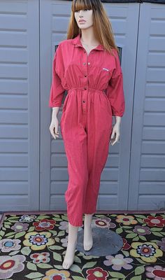 Vintage 80's Adorable red Jumpsuit.  Snap Buttons down the front .Elastic around the waist , would look great with a belt also.  Light fading.  Chest pockets and  hand pockets . Mid weight cotton.    Label: IDEAS.   100% cotton Measurements are taken with item laying flat so widths across must be doubled  size tage says large but it measures more like a medium  Length = 52  in  measured from the shoulder to bottom hem Across under arms =  21  in Across the Waist =  13.5 in  Across the Hips =  22 Retro Jumpsuits And Rompers With Pockets For Fall, Retro Fall Jumpsuits And Rompers With Pockets, Vintage Long Sleeve Jumpsuits And Rompers For Fall, Casual Red Long Sleeve Jumpsuits And Rompers, Casual Red Long Sleeve Jumpsuit, Retro Long Sleeve Jumpsuit For Fall, Retro Long Sleeve Jumpsuits And Rompers For Fall, Vintage Long Sleeve Overalls For Spring, Vintage Jumpsuits And Rompers With Pockets For Spring