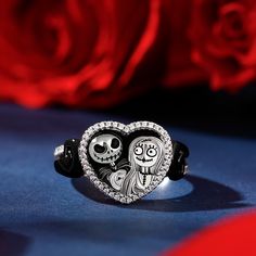 Inspired by a romantic love story of a famous film, it features skull couple with romantic heart, not only light up your Halloween and Christmas, but also light up your love. Crafted in sterling silver and exquisitely designed, it holds an iconic image of characters skull couple atop Spiral Hill, silhouetted against a heart. Sparkling stones also line the ring's slender cathedral shank. The two beige hearts seamed below the center stone manifest the feature of the film, a special charm of the skull couple's love. For fans of this classic movie and of fashion, it's the look you'll want to wear.Carat Weight: 0.379 ctStone Size: 0.8,1 mmStone Type: Jeulia® StoneNumber of Stones: 59 Stone Shape: RoundStone Color: Diamond WhiteWeight: 5.67 gMaterial: 925 SilverPlating Color: Silver, Black Gothic Rings For Valentine's Day Gift, Valentine's Day Gothic Rings As Gift, Black Themed Jewelry For Valentine's Day, Themed Black Jewelry For Valentine's Day, Skull Couple, Romantic Love Story, Romantic Love Stories, Romantic Heart, Halloween And Christmas