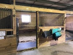 the inside of a horse barn with stalls and stalls