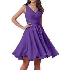 a woman in a purple dress posing for the camera