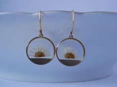 These small round brass frames that are evocative of the sun on the horizon hang from 24k gold plated ear hooks. Available in your choice of real preserved botanical: Queen Anne's Lace is a symbol of sanctuary The Daisy is a symbol of hope Forget-me-nots are known as a symbol of lasting friendship, love, and remembrance Materials are tarnish resistant. However, please see our care section for info on keeping your piece lovely for years to come. All materials are nickel and lead free. Ships in a Yellow Gold Circle Brass Earrings, Yellow Gold Circle Earrings In Brass, Nature-inspired Hoop Earrings As Gift, Nature-inspired Round Hoop Earrings For Gift, Gold Sterling Silver Birth Flower Earrings, Brass Flower Earrings Gift, Pierced Yellow Gold Flower Earrings, Pressed Flowers Yellow Gold Jewelry, Nature-inspired Nickel-free Round Flower Earrings