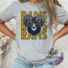 Treat yourself or anyone in your life to this awesome School pride tshirt. This rams school spirit shirt is great for game days!!   Great for all occasions.  And great for supporting your Rams team.  Shirt is made of 95% polyester and 5% spandex. It's soft with great stretch.  To get the best wear from your shirt please  1. Wash with mild detergent  2. Do not use fabric softener  3. Do not use bleach 4. Tumble dry low.  Please enjoy your shirt as I know we have enjoyed all the ones we have made for ourselves!! Please note that every shirt is made to order and normal processing time takes us 5-7 business days to create a shirt and ship out an order; however we strive our very best to get it out sooner!  *some shirts are made by a process called sublimation printing. It is normal if you see Game Day T-shirt With Screen Print For Sports Season, School Spirit T-shirt For Game Day, Sports Fan Graphic Print T-shirt For College, Pre-shrunk Sports Fan T-shirt For Game Day, Football Season Fan Gear T-shirt, Sports Fan T-shirt For Football Season, Team-colored T-shirt With Screen Print For Fans, Pre-shrunk T-shirt For Game Day And Sports Season, Team Spirit T-shirt With Screen Print For Fan Gear