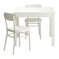 a white table and two chairs sitting next to each other on a white flooring