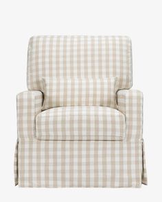 a chair that is sitting up against a white wall and has a checkered pattern on it