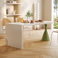 a dining room table and chairs in front of a large window with open shelves on the wall