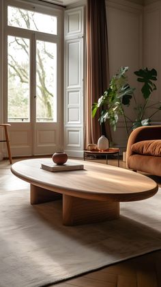 a living room with a couch, coffee table and potted plant