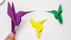 the origami birds are being made with colored paper