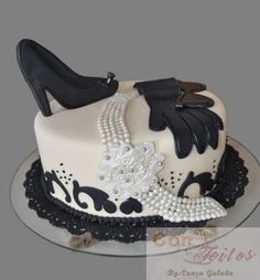 a cake with black and white designs on it's sides, including high heeled shoes