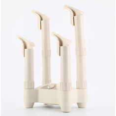 three white toothbrush holders sitting on top of each other