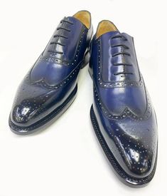 Burnished Calfskin Wingtip Oxford Navy Spectacular & Completely Handmade, this Hand Burnished Calfskin lace-up Wingtip Oxford from the Ugo Vasare collection features Goodyear Welted construction, Brogue Design with Decorative Perforations, soft Calfskin lining, cushioned insole, a stitched welt and a full Leather sole! Matching Belt Available. Don't See Your Size? Call us to arrange a Special Order. Fitted Blue Oxfords With Brogue Detailing, Fitted Blue Oxfords For Business, Semi-formal Blue Leather Shoes, Fitted Blue Leather Shoes For Semi-formal Occasions, Elegant Blue Lace-up Oxfords, Elegant Navy Oxfords With Round Toe, Navy Elegant Oxfords For Business, Elegant Navy Oxfords For Business, Elegant Blue Semi-formal Oxfords