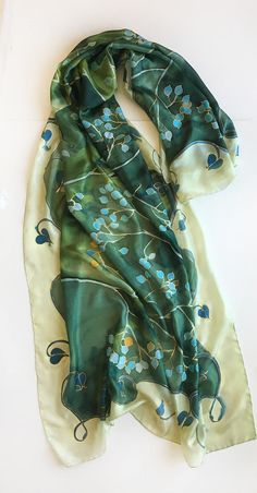 Green Silk Scarf hand painted. Mothers Day gift. Woman fashion wrap in green and aqua colours combo. Handpainted scarves. Art Deco shawl painted. Long Luxurious shawls. Unique handmade scarves. Silk painting, Evening shawl wrap. Garden Wedding accessory. Wedding accessory. Romantic wedding style. Botanical scarf. Olive green silk scarf with turquoise flowers painted in stylized composition. ♥This is a unique, hand painted silk scarf measuring 35 by 70 inches. Silk scarf painted on pure silk 6mm, Green Bohemian Silk Shawl, Green Scarf As Spring Gift, Green Scarves For Spring Gift, Green Scarf For Spring Gift, Green Silk Shawl Scarf, Traditional Handmade Green Shawl, Hand Painted Green Silk Scarf, Artistic Green Silk Scarf, Green Silk Bohemian Scarves