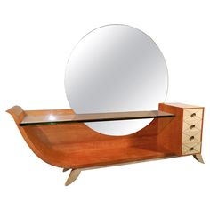 a wooden shelf with a mirror on top of it next to a drawer and cabinet