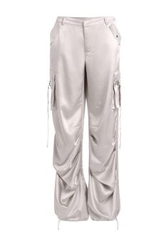 Loose-fitting utilitarian pants featuring side cargo pockets with metal zipper and anglet embellishments. Double back welt pockets, and an adjustable ruched gathered drawstring hem. Can be styled for a mid or low-rise feel. Shown here in Silver. 98% Polyester, 2% Elastane Made in China Model is 5'10" wearing size S Style No. 2760-14 Utilitarian Fashion, Satin Cargo Pants, Light Blue Pants, Australia Clothes, Satin Trousers, Zipper Pants, Cargo Pant, Cargo Pants Women, Blue Pants