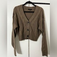 Boutique Quality/Style Chunky Over-Sized Button-Up Cardigan Sweater That Is Perfectly Matched With Boot-Cut, Flair, Skinny Or Distressed Style Pants Trendy Brown Sweater With Button Closure, Beige Cable Knit Button-up Outerwear, Trendy Cable Knit Button-up Outerwear, Brown Button-up Sweater With Button Closure, Brown Button-up Sweater, Brown Button-up Cardigan, Trendy Brown Button-up Cardigan, Oversized Cream Cardigan, Sleeveless Sweater Cardigan