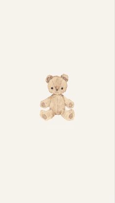 a brown teddy bear sitting on top of a white wall