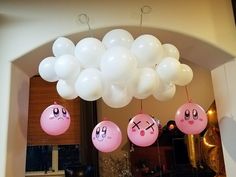 balloons with faces are hanging from the ceiling