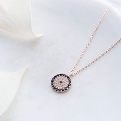 Protect yourself from bad vibes with this unique pendant necklace featuring an Evil Eye Talisman. Perfect for gifting to your loved ones. Ward off the negativity in style. Metal: 925 sterling silver Finish: 18k rose / white gold Charm size: 1.1 cm / 0.43" Chain length: 42 cm / 16.5" Chain style: cable link Clasp: spring ring Hypoallergenic: nickel-free materials used therefore suitable for those with metal allergies Unique Pendant Necklace, Bad Vibes, Evil Eye Necklace, Protect Yourself, Unique Pendant, Eye Necklace, White Rose Gold, Silver Pendant Necklace, Gold Charm