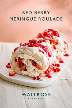 red berry meringue roulade on a white platter