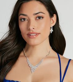 Radiating an elegant sparkle, this rhinestone necklace and earrings set is luxe perfection. It features a V-shaped collar necklace with a single strand of rhinestones leading to two rows of rhinestones and a center marquise-shaped rhinestone embellished design. The duster earrings feature a matching rhinestone design for a chic seamless look. Style this jewelry set with a floor-sweeping ball gown for your next formal affair!Fit & FeaturesNecklace and earrings setV-shaped collar necklace, lobster clasp closureSingle row of rhinestones, two rows of rhinestonesMarquise-shaped rhinestone designDuster earrings, matching rhinestone designPost-back closuresEarrings are final sale and may not be returned or exchanged. Duster Earrings, Earrings Matching, Necklace And Earrings Set, Rhinestone Designs, Accessories Jewelry Necklace, Necklace And Earrings, Rhinestone Necklace, Collar Necklace, Earrings Set