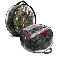 two christmas wreaths are sitting on top of each other in a round case with black straps