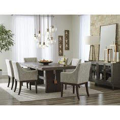 a dining room table surrounded by chairs and a rug