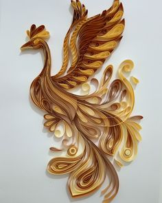 an intricately designed paper sculpture of a bird