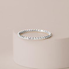 The Glimmer Stacking Ring is a gorgeous piece of jewelry that will add a touch of glamor to any outfit. Made from sterling silver, this ring features a hammered flat dot design that is both unique and stylish. The ring is also stackable, so you can wear it with other rings or on its own. It's available in sizes 2-12, so you can find the perfect fit for your fingers. Whether you're dressing up for a special occasion or just adding a little sparkle to your everyday look, the Glimmer Stacking Ring Month Gifts, Gold Filled Ring, Dots Design, Pretty Rings, Stacking Ring, The Rings, The Ring, Stacking Rings, Artisan Jewelry