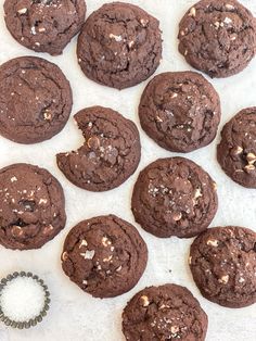 chocolate cookies with sea salt and sprinkles arranged on a white paper towel