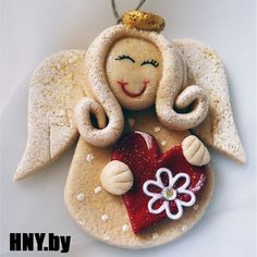 an angel ornament with a heart and flower