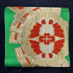 This listing is for a traditional fukuro style obi that features large butterflies in red and gold which are paired facing each other and framed by a wide gold medallion. Behind each pair the medallion sets against an open folding fan. Between the fans are large, nested diamonds in red and gold. The bright green silk background is a strong match with the gold and red of the design. This is a fukuro obi - wide for the entire length, plain on the backside and a patterned design only on the front. There is a one yard "blank" section on the front, as is common with contemporary fukuro obi, where some cost can be saved by leaving it blank where the first wrap layer of the belt portion occurs, since it doesn't show to the public. Length: 13.5' Width: 12" Made In (Estimated): 1960s Condition: Exc Elegant Silk Belted Kimono, Traditional Gold Ceremonial Kimono, Luxury Vintage Embroidered Kimono, Japanese Furisode Kimono, Gold Medallion, Largest Butterfly, Japanese Kimono Vintage 19th Century Framed, Green Silk, Suspender Belt