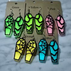 glow in the dark earrings with bats and spider webs on them are available for purchase