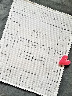 a white crocheted square with a red heart on it and the words i love you written in cursive writing