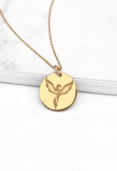 14K 9K Dainty Phoenix Bird necklace, Gold Firebird Necklace, Solid gold Charm necklace, Rebirth Renewal necklace, Minimalist Layering necklace, FREE EXPRESS SHIPPING A dainty disc necklace with an engraved phoenix bird made in solid 9K or 14K solid gold. Phoenix is a mythical firebird that rises from its ashes. It symbolizes rebirth, renewal and eternity and is also representative of hope. Whisper...Hope and Strength rises from the ashes! -------------------------------------------------- D E T Double Horn Necklace, Sun And Moon Necklace, Phoenix Necklace, Solid Gold Charms, Phoenix Bird, Symbol Necklace, Horn Necklace, Solid Gold Necklace, Gold Designs