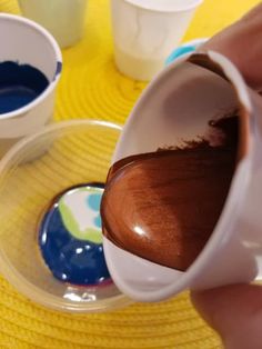 someone is pouring chocolate into small cups